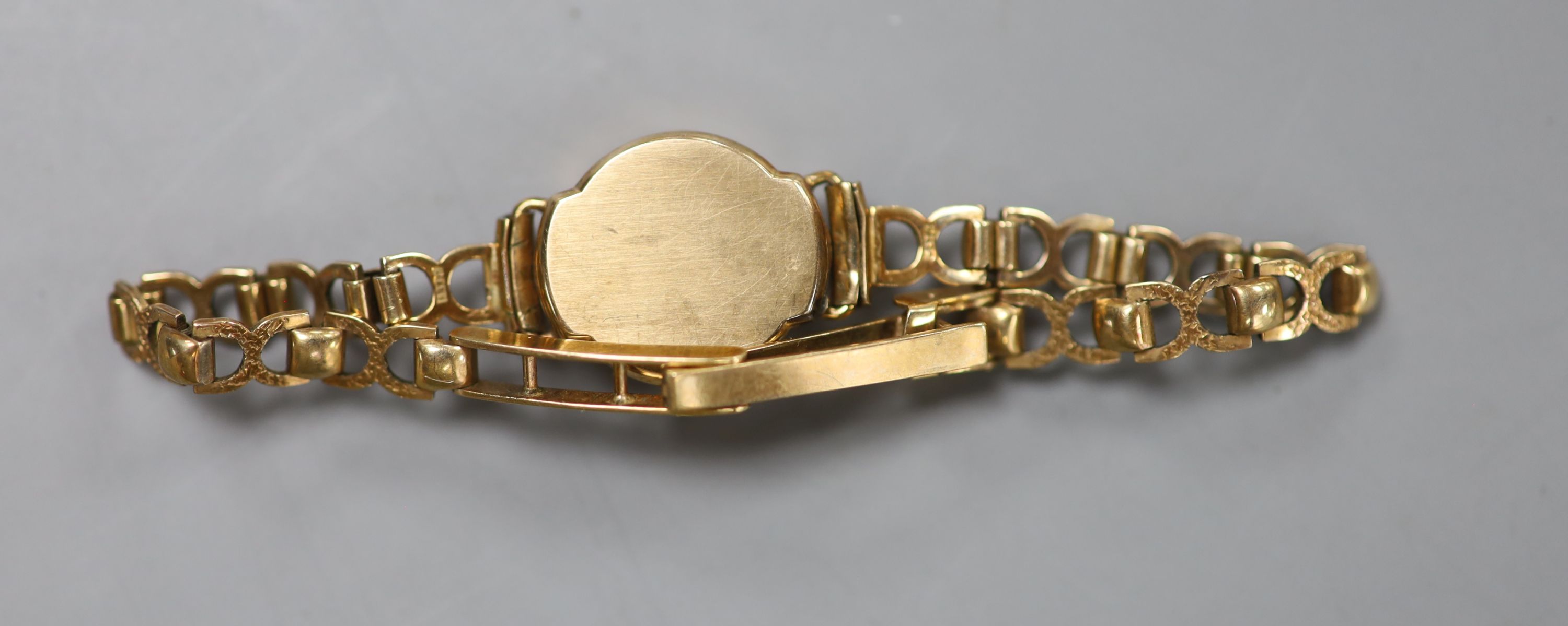 A lady's 9ct god Favre Leuba manual wind wrist watch, on a 9ct gold bracelet